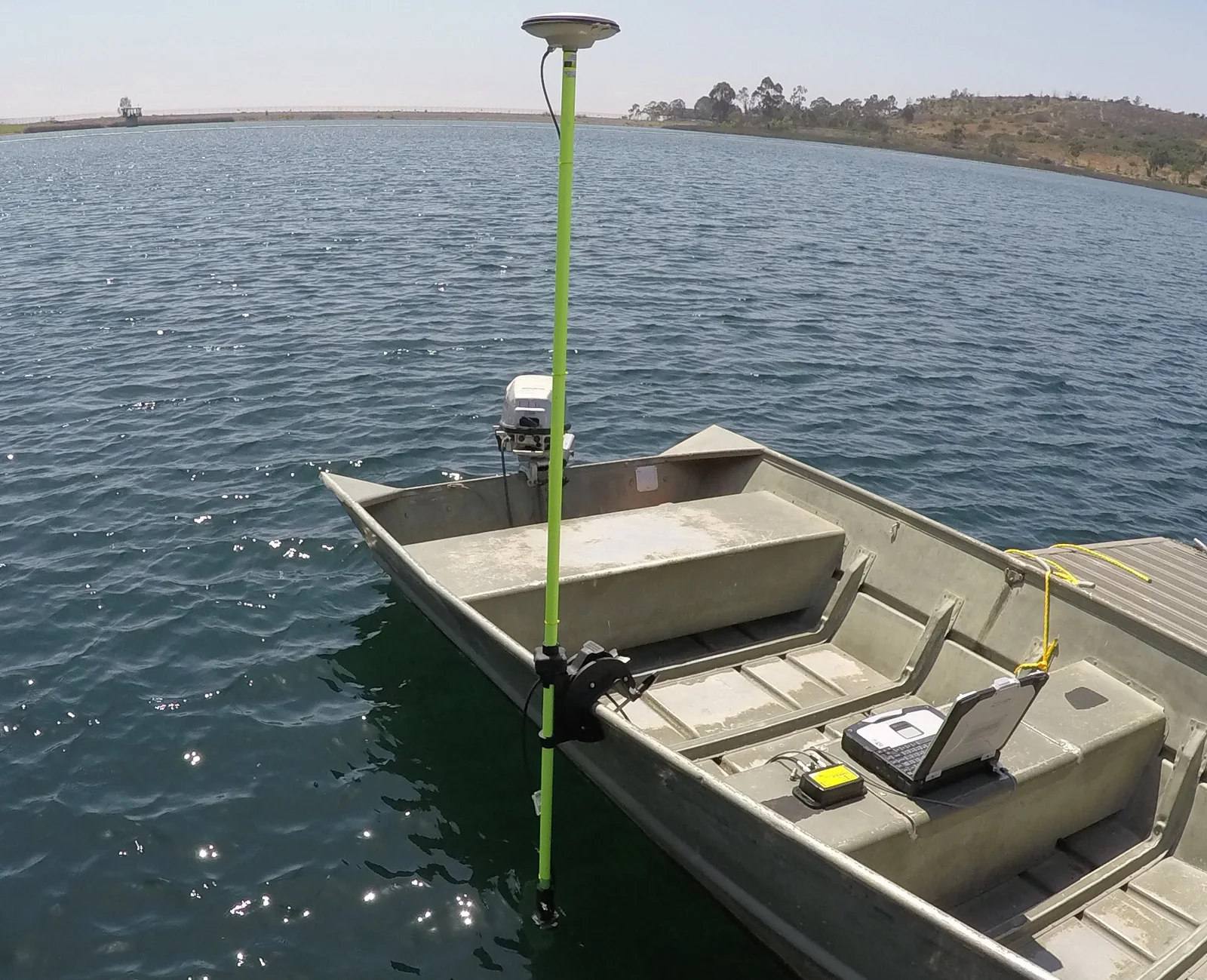 5/8 inch survey pole with GNSS antenna on a small aluminium boat