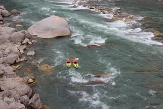 Two kayaks surveying a rocky Bhutan river seen from above