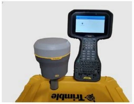 Trimble GNSS receiver and data collector sitting on a yellow CEE ECHO case