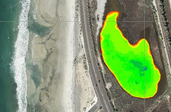 Colour-coded bottom elevation map of the lagoon over an aerial image beside the coast road