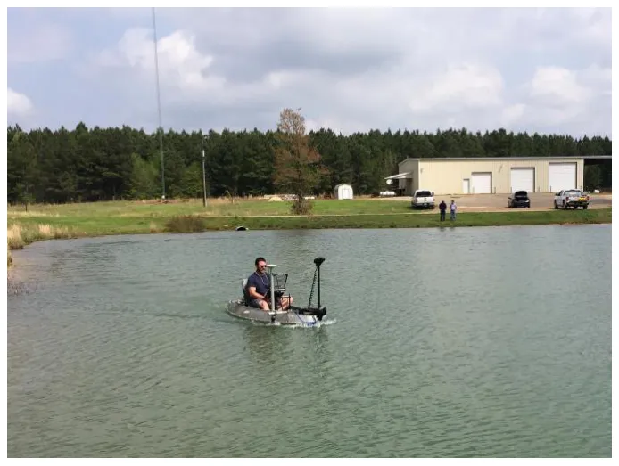 Small manned boat surveying a frac pond.