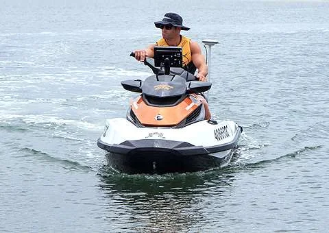 Surveyor riding the CEE JET personal watercraft toward the camera
