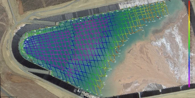 Colour-coded survey lines and depths over an aerial image of a tailings dam