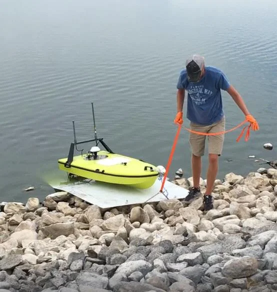 CEE-USV being launched from a rip rap lagoon bank